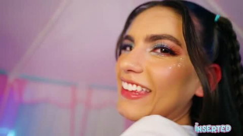 Isa Bella smiling with glitter makeup and braids