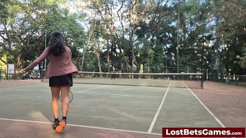Outdoor tennis strip game with brunette in pink top and black skirt