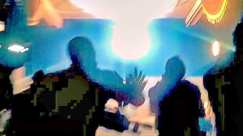 Silhouetted figures in futuristic porn scene with glowing stage lights