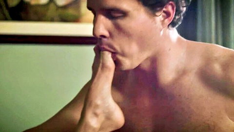 Muscular handsome man sucks woman's toes passionately in steamy foot fetish closeup