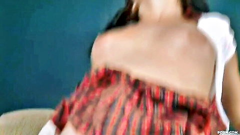 Brunette with long hair and small tits exposes shoulders in white top pulling red dress teasing blowjob pose