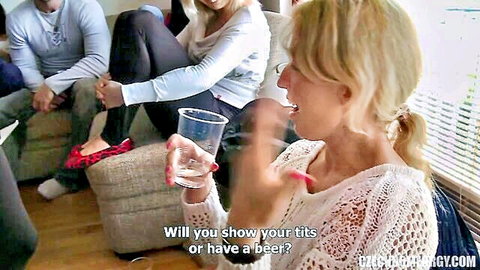 Blonde woman in lace top offers tits or beer at amateur home orgy party