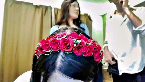 Shy baby bunny model with long dark hair wearing pink rose crown in backstage prep