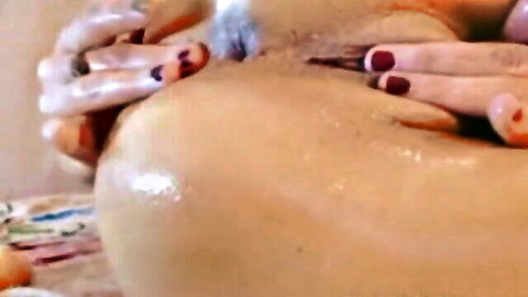 Red-nailed fingers spreading shiny wet creamy pussy lips close-up