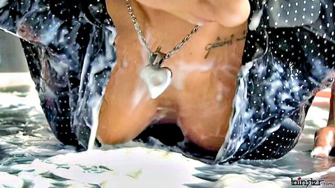 Skinny young brunette's medium tits exposed and drenched in milk from open wet shirt