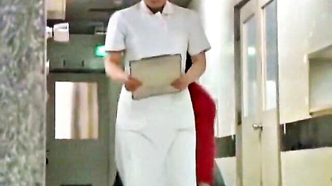 Sexy nurse in white uniform skirt holding clipboard in hospital hallway