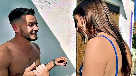 Sandrillon in blue bikini smiling with shirtless man outdoors