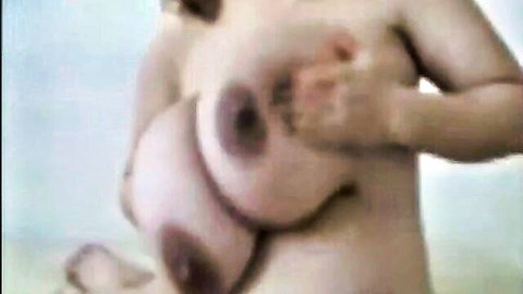Pregnant woman with massive boobs exposing her large lactating breasts