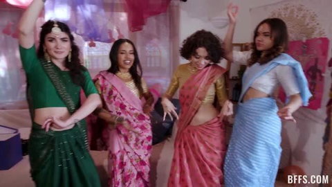 Four Indian women in colorful sarees dancing at bachelorette party