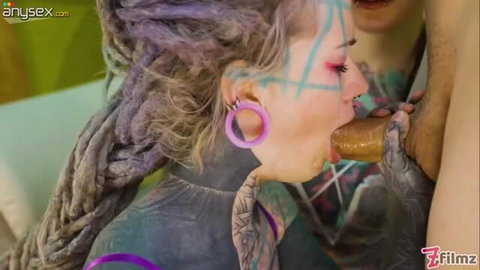 Tattooed babe with purple hair giving deepthroat blowjob in threesome