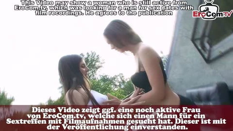 Two women in black lingerie intimate on balcony, softcore lesbian scene