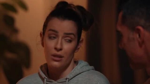Marica Chanelle in grey hoodie looking at man, close-up intimate scene