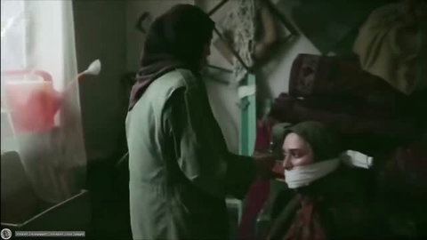Amateur bondage scene with gagged female victim in headscarf