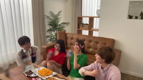 Japanese group of four young adults laughing casually on couch with snacks