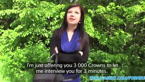 Brunette woman in blue top holding black bag outdoors, Public Agent interview offer