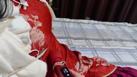 Asian teen in red qipao dress with black sex toy