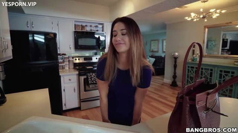 Eva Lovia standing in kitchen wearing tight blue dress