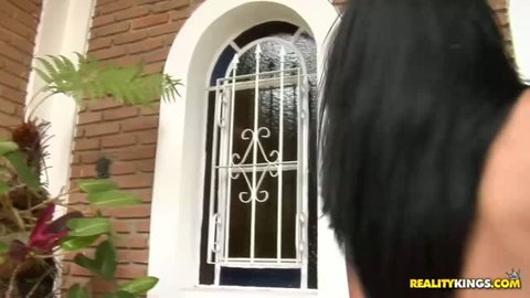 Cristal shows her back and dark hair near arched window with bars