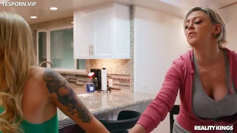 Blonde tattooed woman in green top with mature blonde in pink hoodie