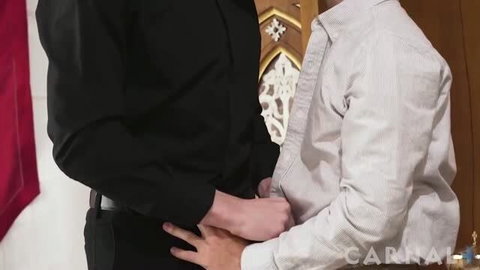 Two men in formal attire embracing, one in black shirt, one in pinstripe shirt