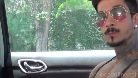 Tattooed Brazilian man with sunglasses in car selfie thumbnail