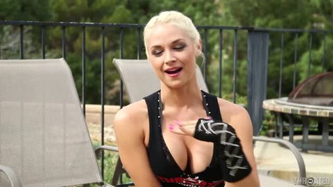 Sarah Vandella in black studded top showing cleavage on patio