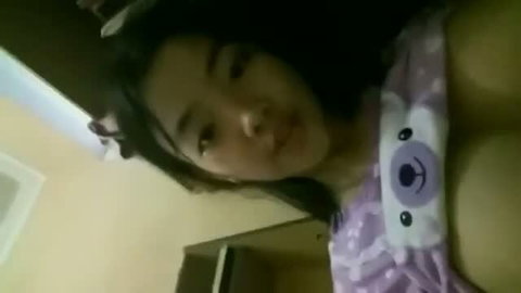 Young Asian woman in purple koala pajama top, close-up selfie