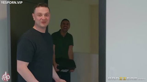 Two men in black and green shirts standing in doorway