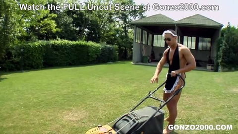 Muscular man in maid outfit mowing lawn with cage visible