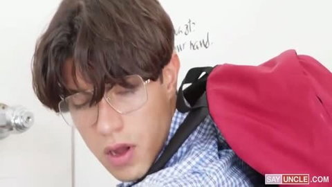 Young man in glasses and blue checkered shirt with backpack in bathroom