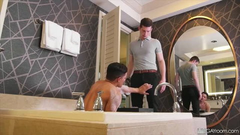 GayRoom Bonus Tip Service: muscular shirtless man in bathtub reaching for standing clothed man