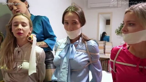 Three women bound and gagged with tape and rope, wearing satin blouses