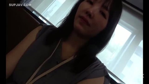 Asian woman with black hair in gray sleeveless top, close-up face