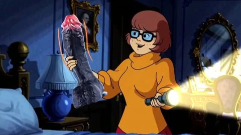 Velma from Scooby Doo holding large dildo with flashlight in dark room
