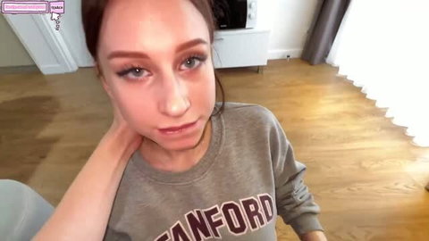 Brunette in Stanford sweatshirt close-up with makeup and glossy lips