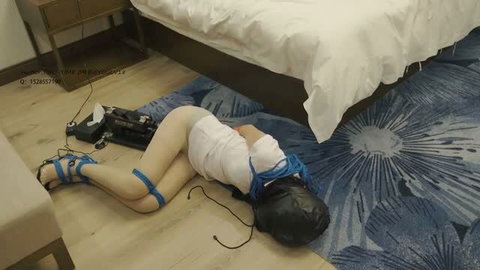 Asian woman bound in blue ropes with black breathplay hood and fucking machine