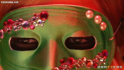 Masked redhead in green jeweled mask, seductive close-up