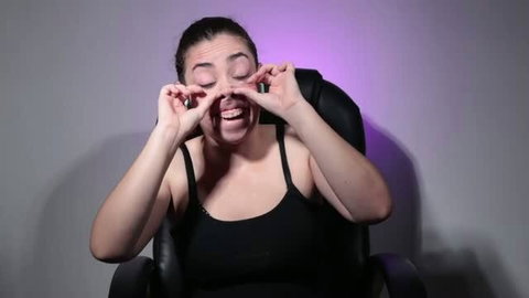 Colombiakinkygirl making silly faces with mouth open in black tank top