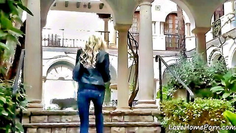 Blonde girl in leather jacket and jeans, lost in the city outdoors