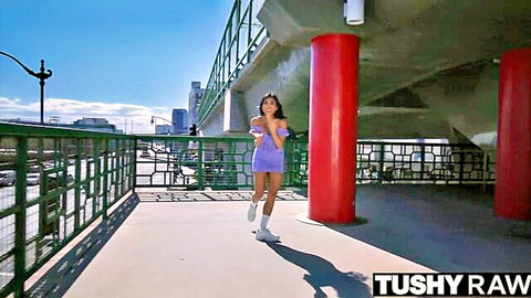 Ember Snow struts in tight purple mini dress outdoors, teasing walk