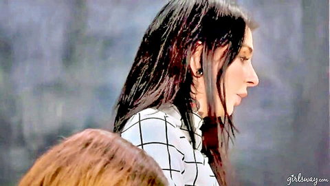 Brunette model in checkered shirt profile view with wet hair and piercing gaze