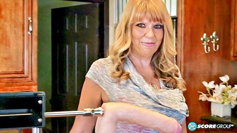 Blonde MILF teases in kitchen with fucking machine rod against her arm