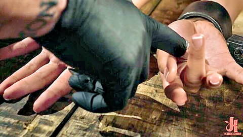 Gizelle Blanco in BDSM tease with gloved hand on her fingers