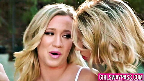 Two blonde lesbians in white tops with open mouths in close teasing face-off