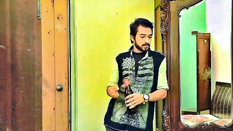 Indian husband in casual green vest holding beer, exotic vibe