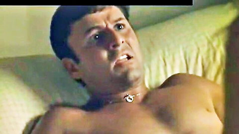 Jordan Ladd adult scene with shirtless muscular man lounging on bed