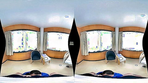 Asian woman in blue pants lying on floor, talking on phone in VR bedroom scene
