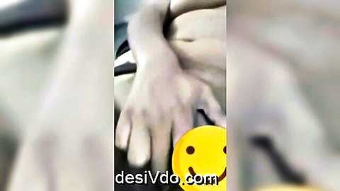 Blurry video call thumbnail with hand holding yellow smiley face