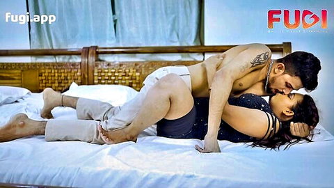Indian couple in passionate spooning pose, intense kissing and embrace