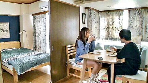 Curvy Japanese teen babe in hoodie and tiny shorts sits teasingly with guy at table